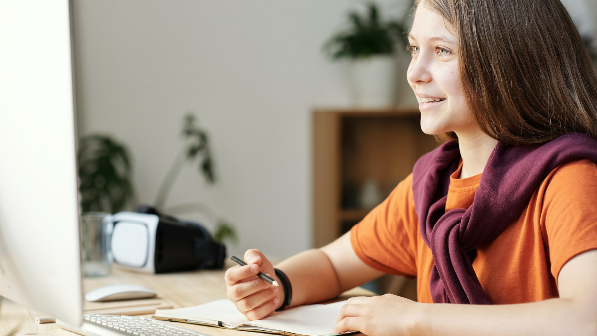 girl smiling at computer.png